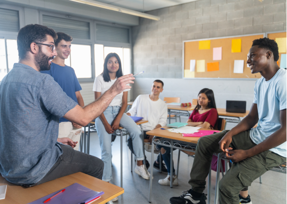 Teacher discusses with students in a classroom